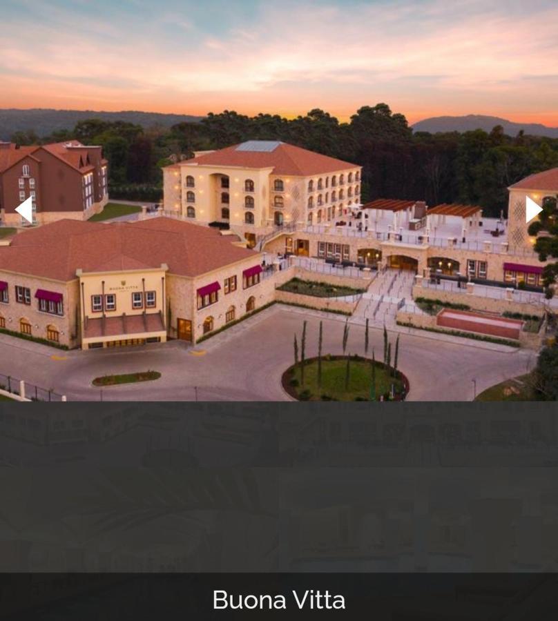 Buona Vitta Gramado Resort & Spa By Gramado Parks Экстерьер фото The image shows a large, modern building complex, likely a hotel or resort. The architecture features a combination of traditional and contemporary design elements. Surrounding the main building are landscaped areas, including trees and green spaces,