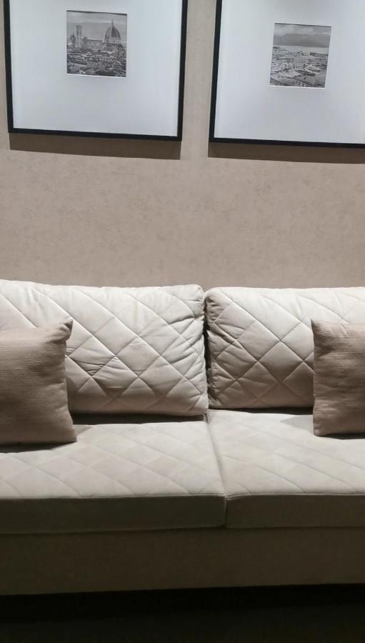 Buona Vitta Gramado Resort & Spa By Gramado Parks Экстерьер фото The photo shows a section of a couch with two large, quilted back cushions that have a diamond pattern. There are also two smaller, square pillows placed in front of the back cushions. The color scheme appears to be neutral, featuring shades of beige